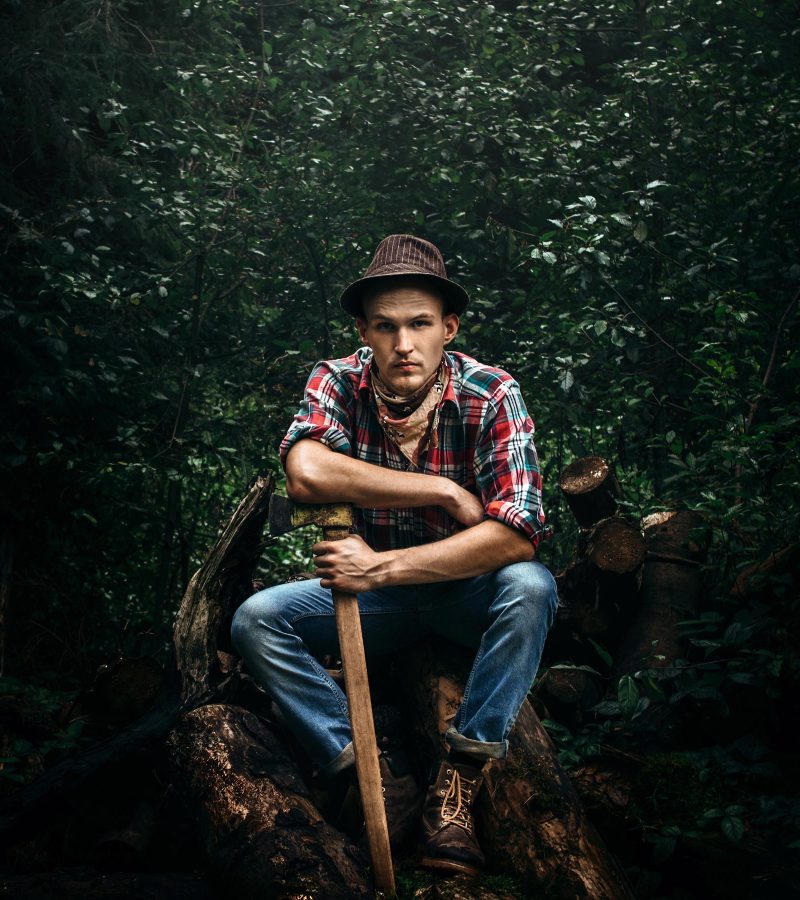 stylish-hipster-lumberjack-with-ax-in-the-sunny-fo-68HK3E8.jpg